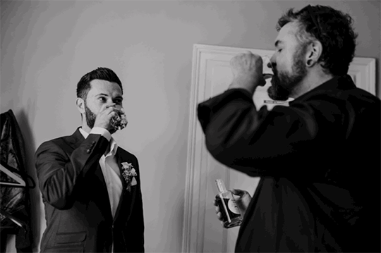 Bräutigam und sein Trauzeuge trinken Schnaps
